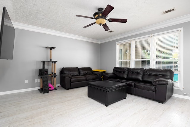 living room featuring crown molding, light hardwood / wood-style floors, and a healthy amount of sunlight