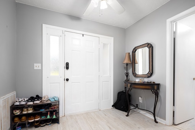 entryway with light hardwood / wood-style flooring and ceiling fan