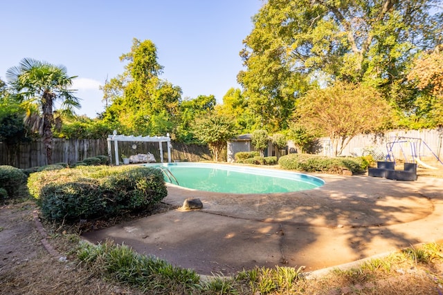 view of swimming pool featuring a pergola and a patio area