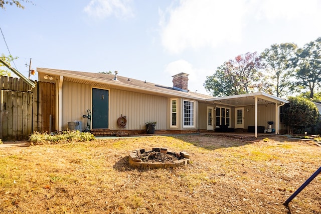 back of house featuring a fire pit