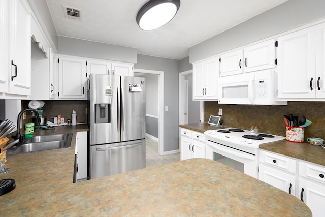 kitchen featuring tasteful backsplash, white appliances, sink, and white cabinets