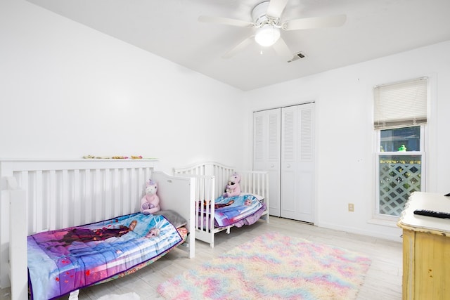 bedroom with a closet, ceiling fan, and light wood-type flooring