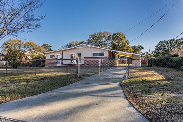 view of front of home with a carport and a front lawn