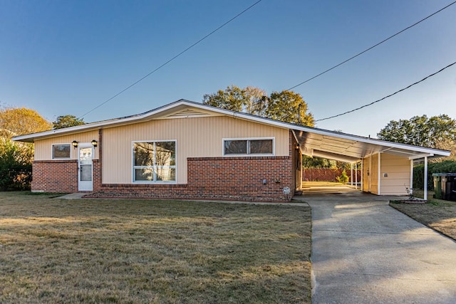 view of front facade with a carport and a front lawn