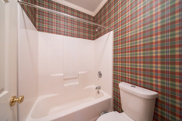 bathroom featuring crown molding, toilet, and shower / bathing tub combination