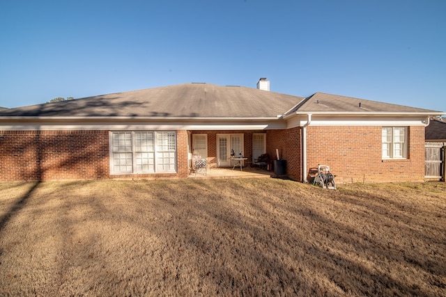 back of property featuring a yard