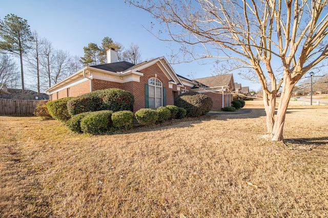 view of home's exterior with a lawn