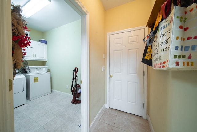 washroom featuring washing machine and dryer and cabinets