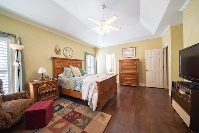 bedroom featuring ceiling fan, a tray ceiling, dark hardwood / wood-style flooring, and ornamental molding