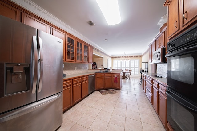 kitchen featuring hanging light fixtures, ornamental molding, black appliances, and light tile patterned flooring