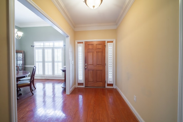 entryway with crown molding and hardwood / wood-style floors