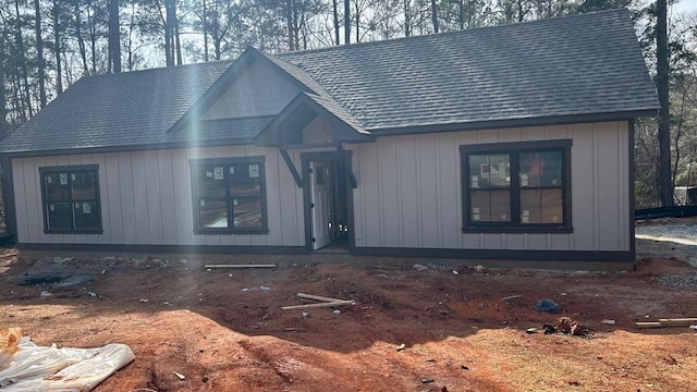 view of front of home with board and batten siding and a shingled roof