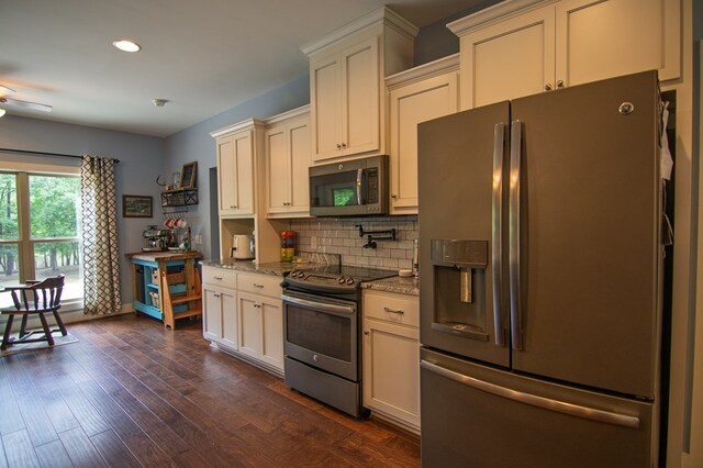 299 Savior Ln, Hamilton, GA 31811 - kitchen with appliances with stainless steel finishes, light stone counters, tasteful backsplash, recessed lighting, and cream cabinetry