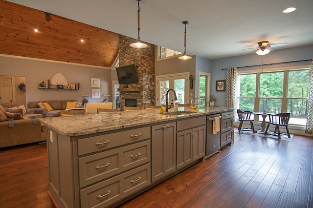 299 Savior Ln, Hamilton, GA 31811 - kitchen with open floor plan, stainless steel dishwasher, a ceiling fan, a fireplace, and vaulted ceiling