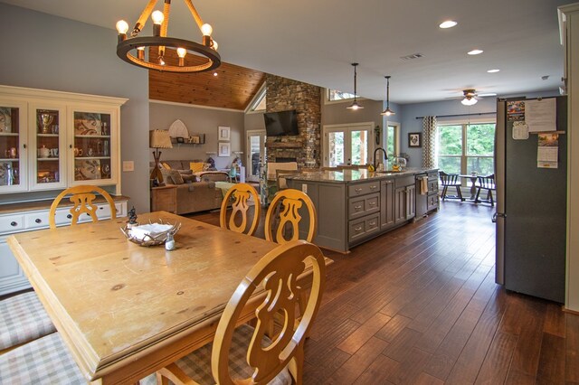 299 Savior Ln, Hamilton, GA 31811 - dining room featuring dark wood-style flooring, recessed lighting, a chandelier, a ceiling fan, and a stone fireplace