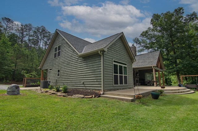 299 Savior Ln, Hamilton, GA 31811 - view of home's exterior featuring a patio, roof with shingles, a yard, and faux log siding