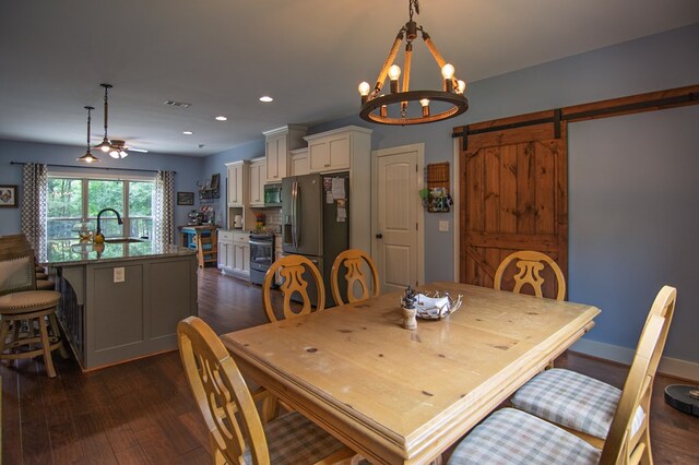 299 Savior Ln, Hamilton, GA 31811 - dining area featuring dark wood-style floors, a barn door, recessed lighting, a chandelier, and a ceiling fan