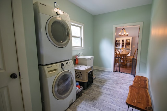 299 Savior Ln, Hamilton, GA 31811 - laundry area featuring estacked washer and dryer, a chandelier, and light wood-style floors
