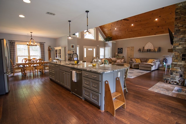 299 Savior Ln, Hamilton, GA 31811 - kitchen with stainless steel appliances, gray cabinets, light stone countertops, dark wood finished floors, and decorative light fixtures