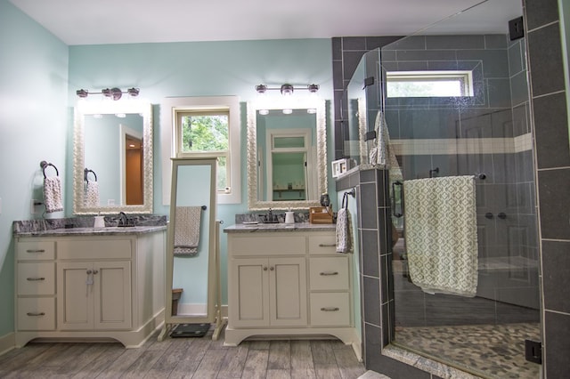 299 Savior Ln, Hamilton, GA 31811 - full bath featuring wood finished floors, a stall shower, and two vanities