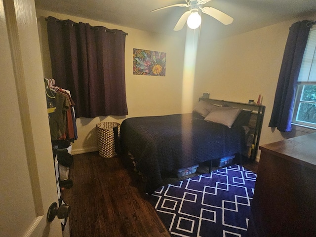 bedroom featuring dark hardwood / wood-style flooring and ceiling fan