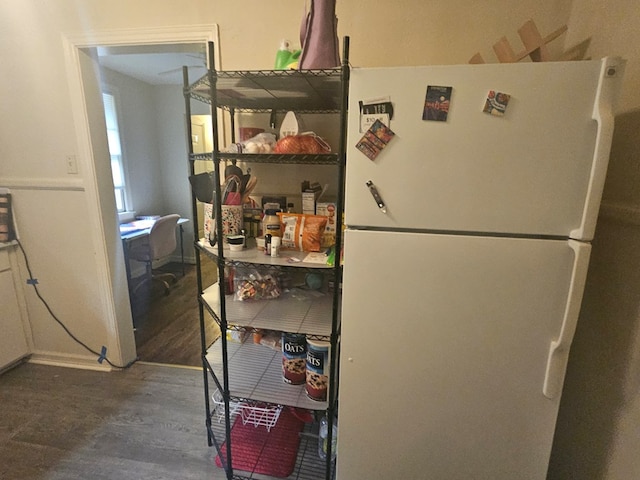 kitchen with dark hardwood / wood-style floors and white fridge