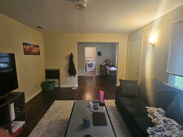 living room with dark hardwood / wood-style flooring