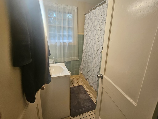 bathroom featuring a shower with curtain, tile patterned flooring, and vanity