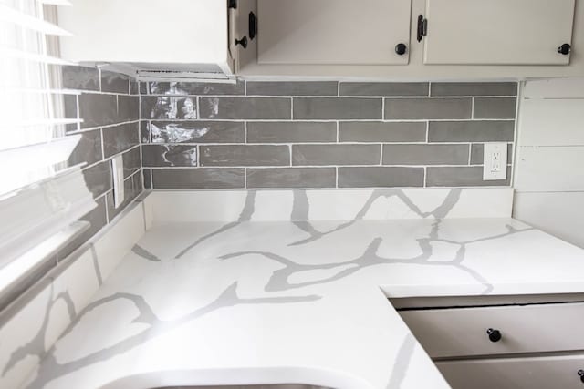room details with backsplash and light stone counters