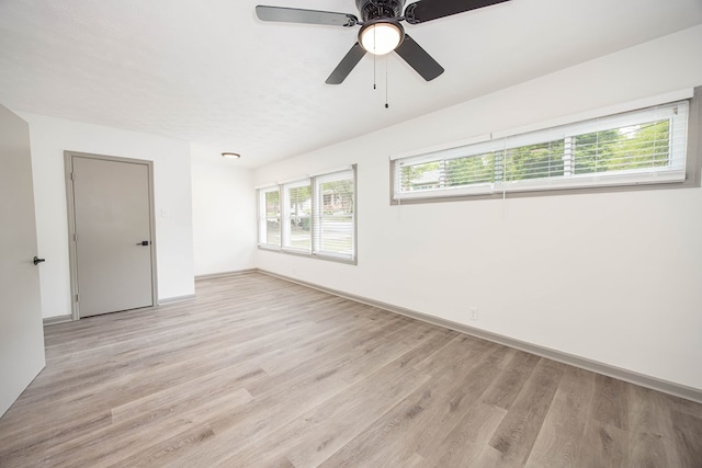unfurnished room with light wood finished floors, baseboards, and ceiling fan