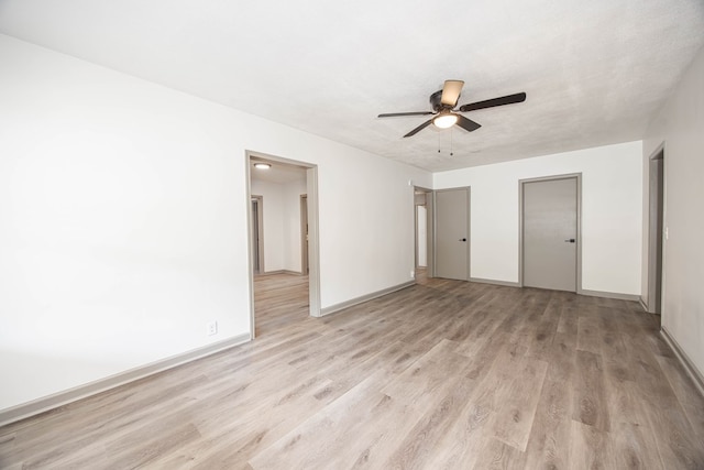 unfurnished bedroom with ceiling fan, baseboards, and light wood finished floors
