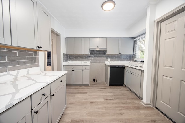 kitchen with gray cabinets, dishwasher, and light stone countertops