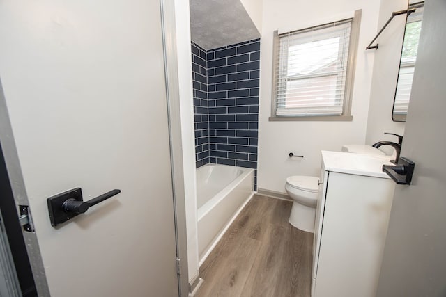 full bathroom featuring toilet, vanity, wood finished floors, and baseboards