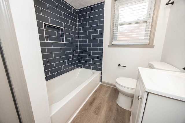 full bath featuring toilet, vanity, wood finished floors, and baseboards