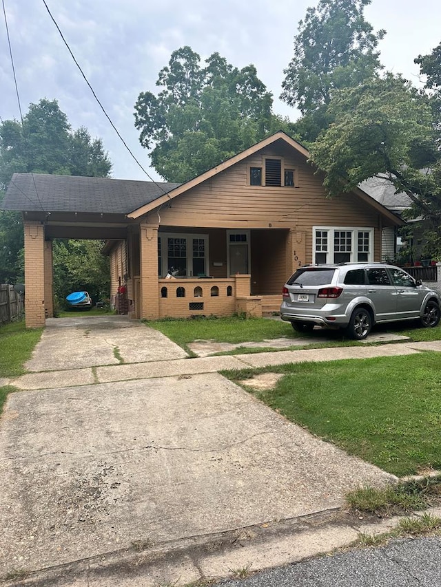 view of front facade with a front lawn and a carport