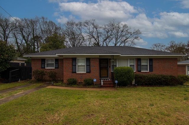 single story home featuring a front yard, fence, and brick siding