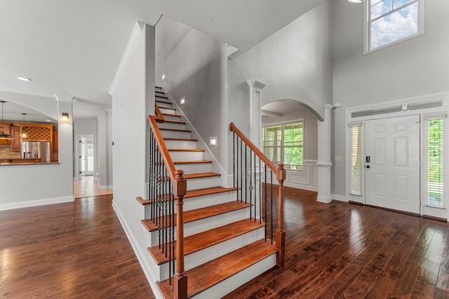 30 Pleasant Ct, Cataula, GA 31804 - entrance foyer with ornate columns, arched walkways, wood-type flooring, stairway, and a towering ceiling