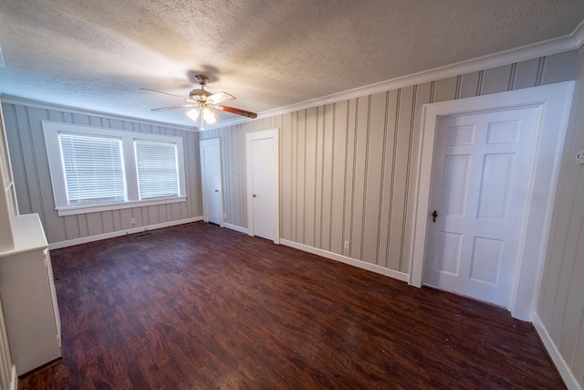 interior space featuring crown molding, dark wood-type flooring, a textured ceiling, and ceiling fan