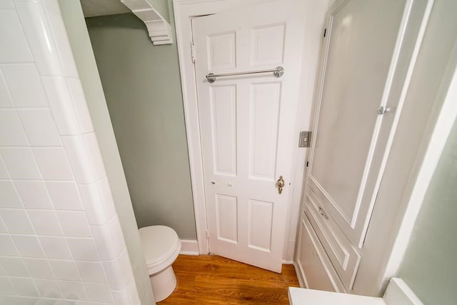 bathroom featuring hardwood / wood-style floors and toilet