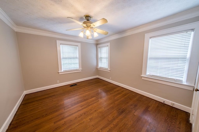 empty room featuring crown molding, dark wood-type flooring, a textured ceiling, and ceiling fan