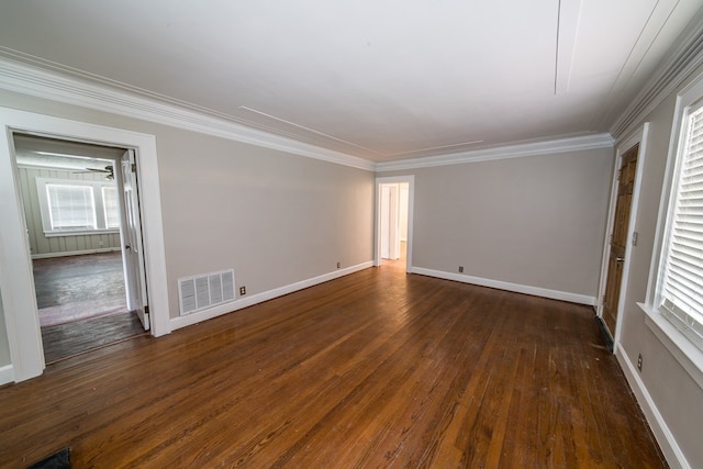 empty room featuring crown molding and dark wood-type flooring