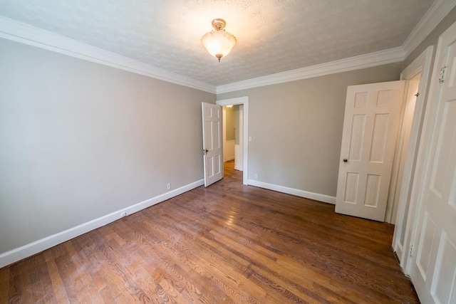 unfurnished bedroom with crown molding, hardwood / wood-style flooring, and a textured ceiling