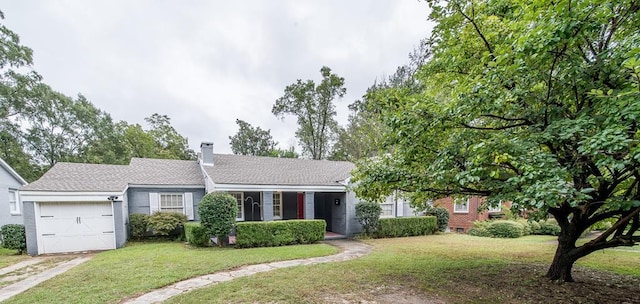 view of front of property with a garage and a front yard