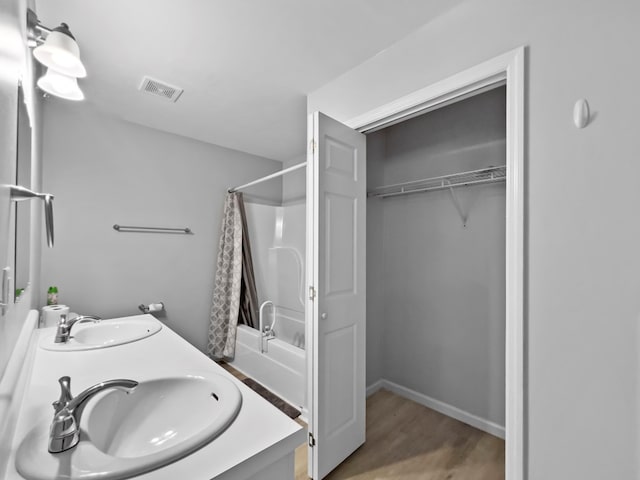 bathroom featuring vanity, shower / tub combo, and hardwood / wood-style flooring