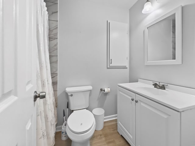 bathroom featuring vanity, toilet, and hardwood / wood-style floors