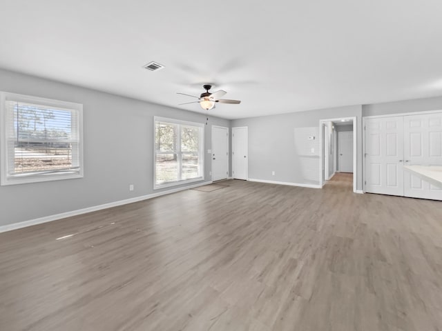 unfurnished living room featuring ceiling fan and light wood-type flooring