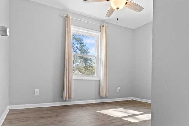 spare room with hardwood / wood-style flooring and ceiling fan