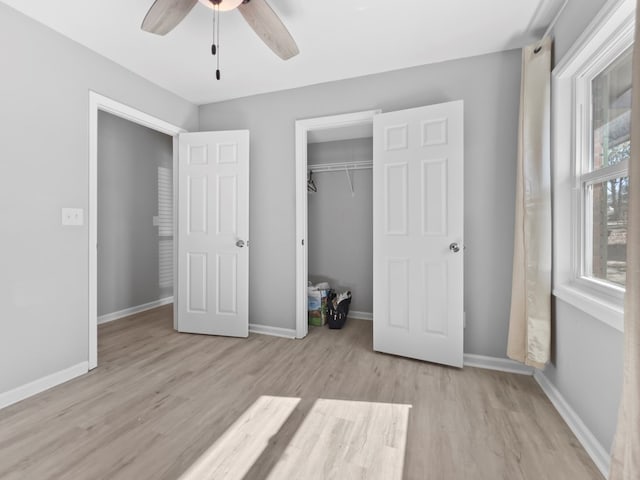 unfurnished bedroom with ceiling fan, light hardwood / wood-style floors, and a closet