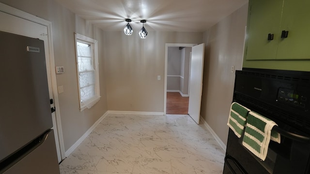 4525 Sentry St, Columbus, GA 31907 - kitchen with freestanding refrigerator, light marble finish floors, and oven