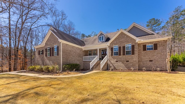 view of front of property featuring a front yard, brick siding, and crawl space